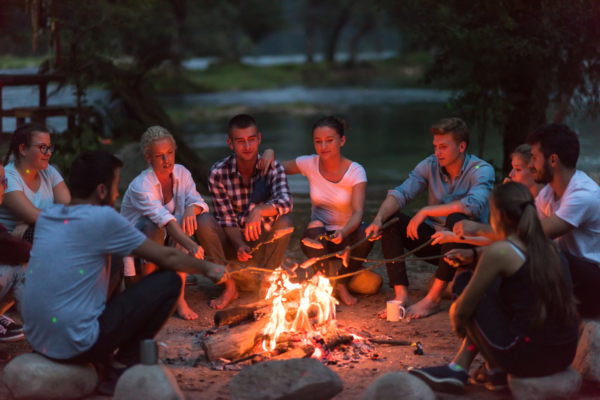 Young Friends Relaxing around Campfire